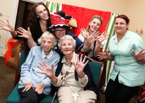 Staff and residents of Kenilworth Manor with characters from the pantomime