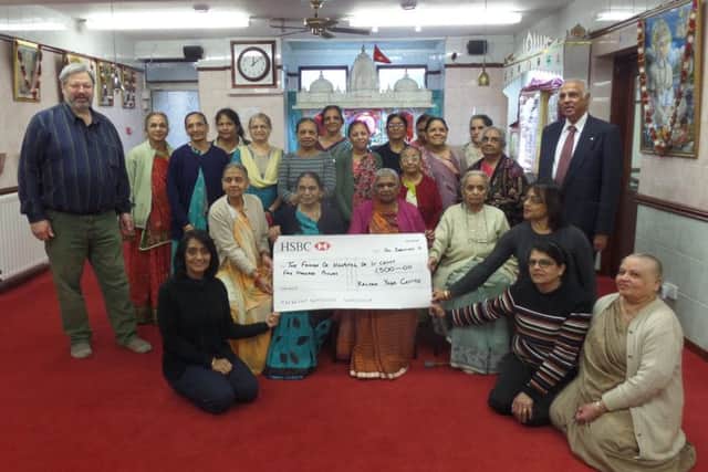 Members of the Kalyan Yoga Centre present a cheque to Friends of St Cross trustees Willy Goldschmidt and Ramesh Srivastava. NNL-170901-220654001