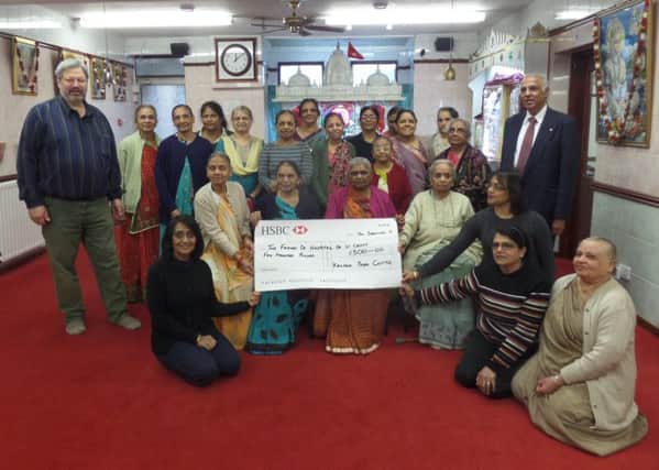 Members of the Kalyan Yoga Centre present a cheque to Friends of St Cross trustees Willy Goldschmidt and Ramesh Srivastava. NNL-170901-220654001