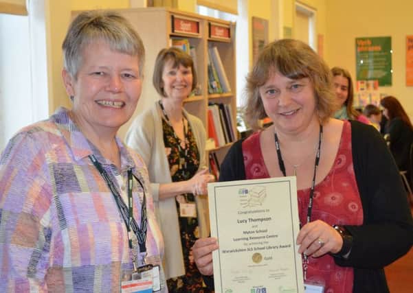Stella Thebridge from the Schools Library Service presenting the Gold Award to Myton Schools Library Manager, Lucy Thompson