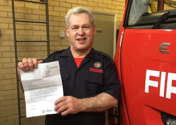 Malcolm Gunter with his letter from chief fire officer Andy Hickmott about his invitation to the Queen's Garden Party.