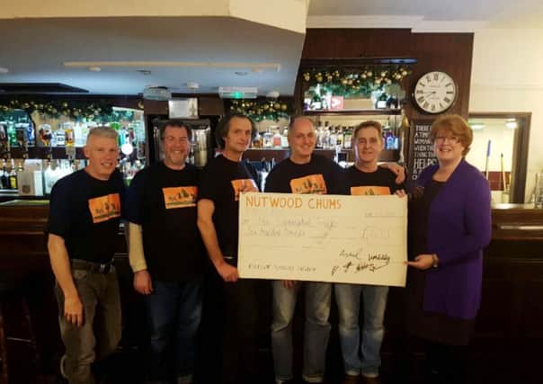 Presenting their cheque for Â£600 from the reunion to Helen Ure of The Hummingbird Centre in Regent Place are (from left) Steve Grimes,  Lez Wake, John Wilson, Nick Shergold  and Bull landlord Paul Stanley.