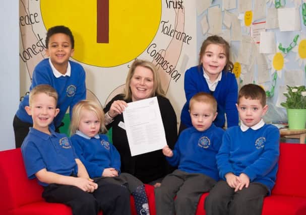 Staff and pupils are celebrating the school's best rating from Ofsted and head teacher Abi Huggins is pictured here with some of the pupils. NNL-170125-094443009