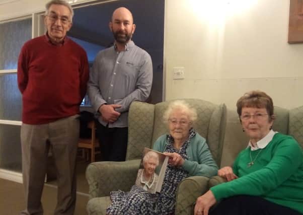 Irene Whittaker with her card from the Queen, pictured with (L-R) her son-in-law Ron Hill, son Mike Hill and Daughter Susan Hill.