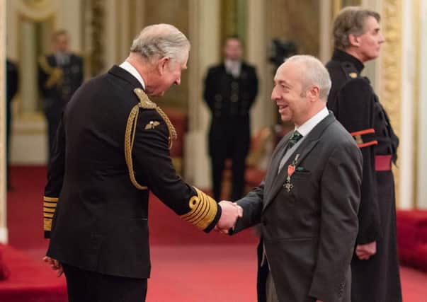 Chris Worman, Rugby Borough Council's parks and grounds manager, receives his MBE medal from Prince Charles. (Photo courtesy of The Crown)