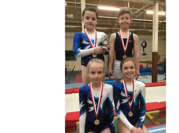 Rugby Gymnastics Club's tumbling team with their gold medals