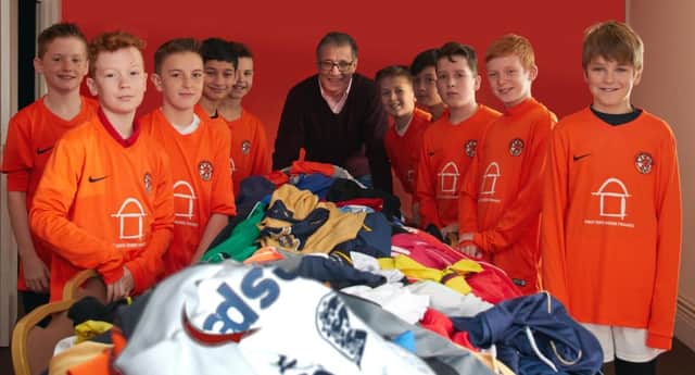 MP Mark Pawsey thanking Rugby Town JFC players for the shirts for Rwanda