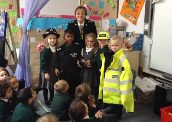 The children celebrate with Anita Clarke, International Police Woman of the Year.