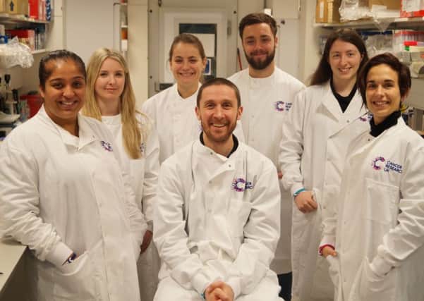 Dr Stephen Royle (centre) with his lab team
