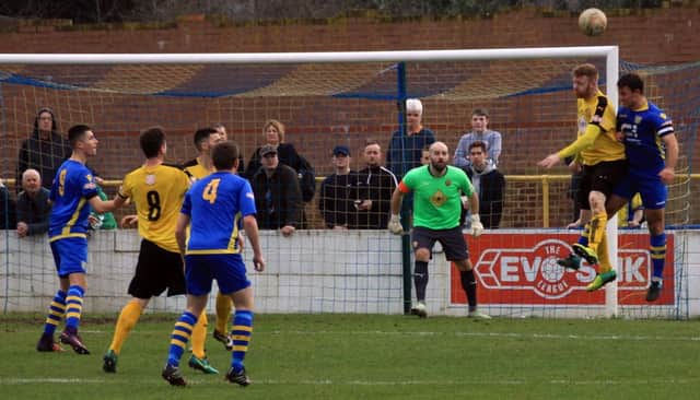 Jamie Hood gets up to clear the danger on another quiet day for Brakes keeper Tony Breeden.  Picture: Sally Ellis