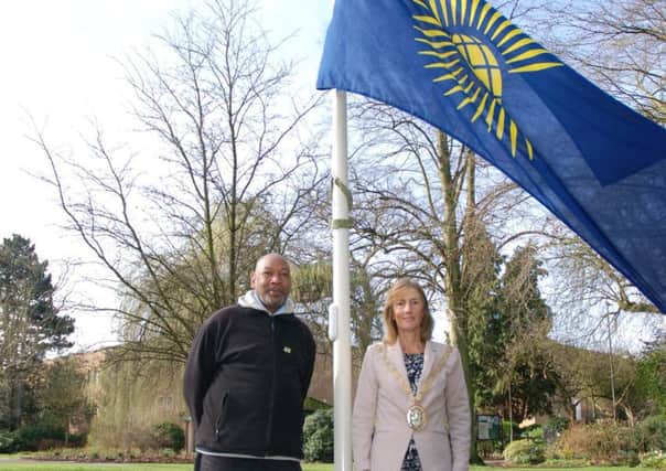 Former Commonwealth Games sprinter Trevor Hoyte and Mayor Cllr Sally Bragg with the Commonwealth flag. NNL-170313-170550001