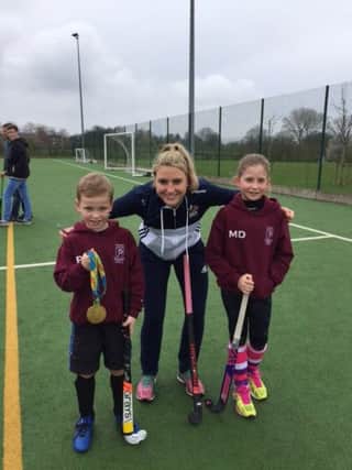Lily Owsley shows off her Olympic gold with youngsters from Leamington Hockey Club. Picture submitted