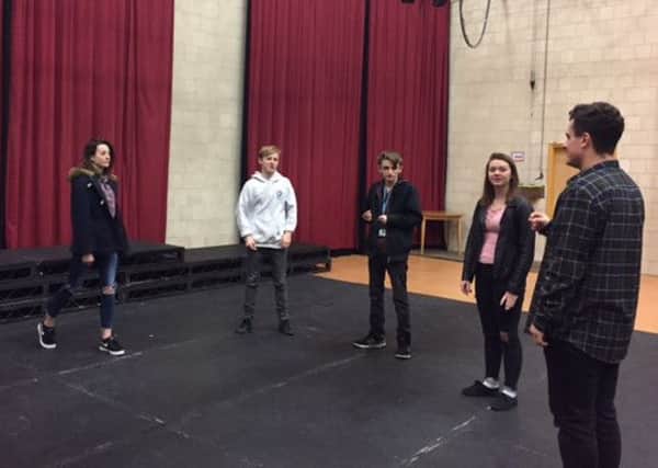 Students rehearse for the play.
