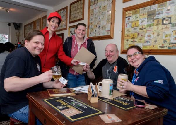 A real-life mystery game was staged in Rugby recently, with clues to find placed around the town and in a number of the shops and pubs.  Pictured: Colin Arthur (Owner - Rugby Tap), Nicky Main (Rugby Theatre), Laura Blackwell together with Martin & Joanne Bannister. NNL-170320-102901009