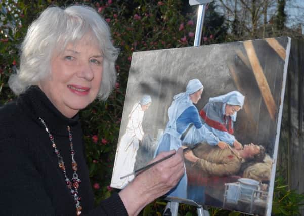 Cynthia with one of her paintings.