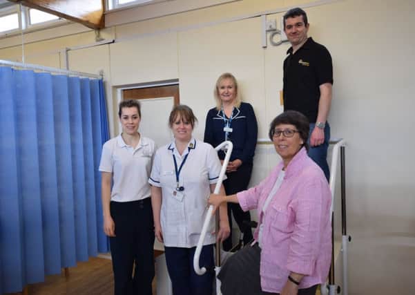 From left: Physiotherapists Kate Roper, Debbie Taylor and Cheryl Ritchie, with Margarita Hart (front) and Ian Grigg (back), on the new stairs in Kenilworth Clinic