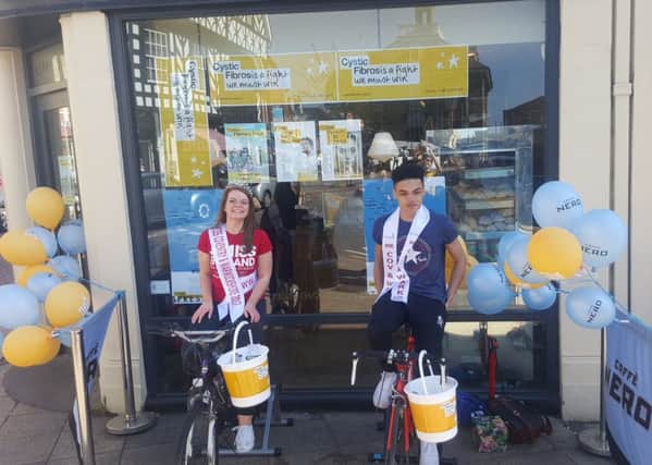 Miss and Mr Coventry and Warwickshire taking their turn on the static bikes outside Caffe Nero in Warwick to raise money for Cystic Fibrosis.