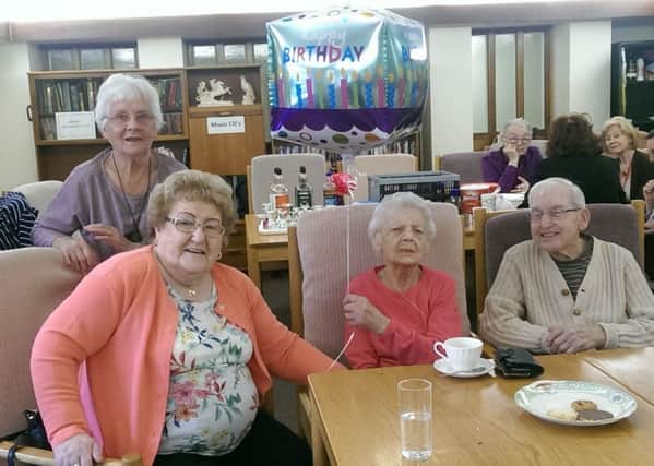 Flo Young (holding the balloon) celebrates her 101st birthday with other members of the Age UK Thursday Lunch Group at Chandon Court in leamington.