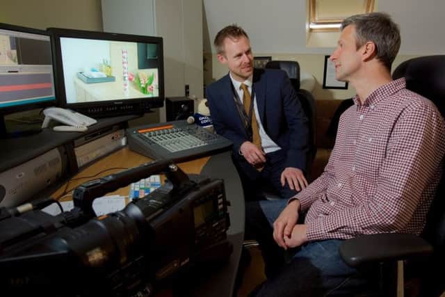Stuart Kettell with a member of West Midlands Police's cybercrime team. Photo: West Midlands Police NNL-170413-120027001