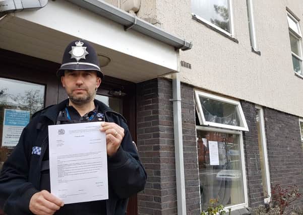 PC Andy Whiston of Leamington Safer Neighbourhoods Team outside 3 Epperstone Court in Leamington. Photo by Warwickshire Police.