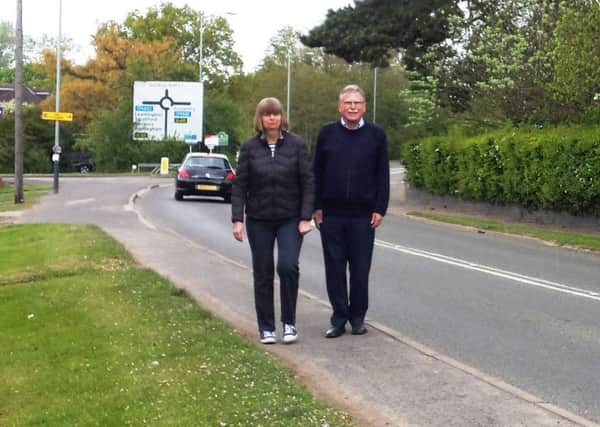 Councillors Jenny St John (Warwick North) and John Holland (Warwick West) in Birmingham Road where the speed limit is being reduced to 30 mph.