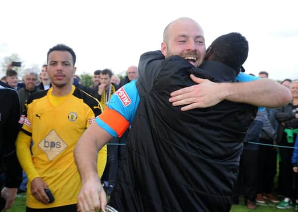Tony Breeden is congratulated by Ahmed Obeng after the final whistle. Pictures: Morris Troughton