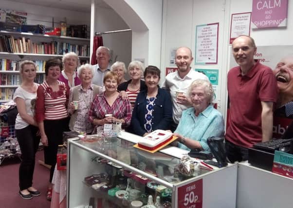 Members of the Myton Hospices Warwick Street Shop team from L-R Kasia Stanczak, Alison McKellar, Eve Roberts, Janet Cooper, Phil Roberts, Chris Murphy, Joan Perry, Heather Alleyne, Ann Haynes, Kingsley Hasler (Manager), Vera Oughton (with the cake) and Phil Ferriday.