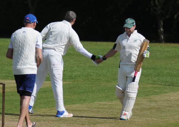 Rowington's Scott Rogers sportingly congratulates Will Lawton after dismissing him for 87.