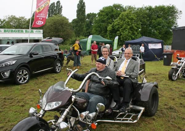 Town deputy mayor Kate Dickson and consort Richard Dickson arriving by motor trike to open the 2016 Show.