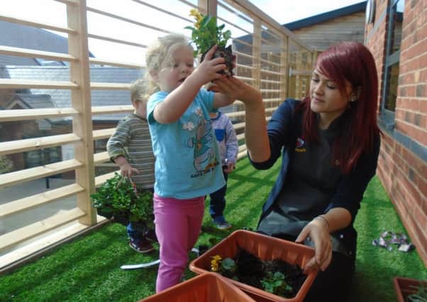 Children at Busy Bees nursery in Warwick getting hands on with gardening in honour of the Chelsea Flower Show.