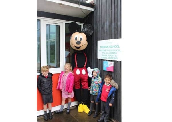 Thorns Community Infant School pupils with the PTA's Mickey Mouse scarecrow