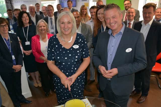 From left: Christine Asbury, WCS Care CEO, cuts the lightbulb cake at the launch with Ed Russell, WCS Cares Director of Innovation and Delivery, along with partner organisations and invited guests.
