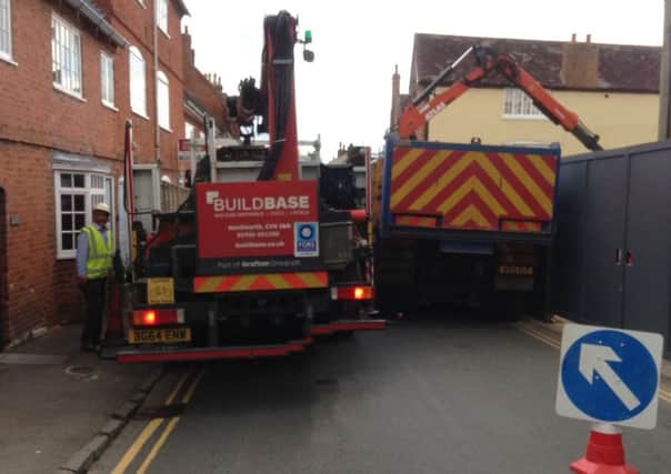 A lorry (left) mounting the pavement trying to pass the parked lorry (right) outside 39 High Street