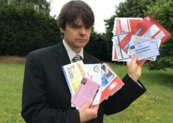 Simon Cripwell of Warwickshire Trading Standards with some of the scam mail people have received.
