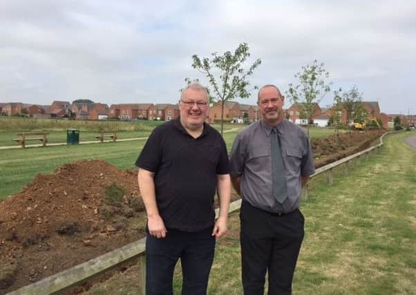 Councillor Martyn Ashford with Tim Coates from Taylor Wimpey at Tapping Way with new trenches and mounds. ABCDE NNL-170725-121630001