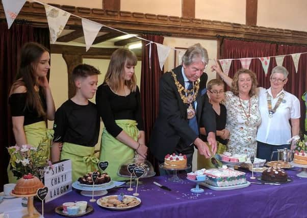 Lauren, Tom and Hannah Fardoe with Helen and Edward Smith of the Evelyn's Gift Charity and Pauline Fanti President of Warwick Lions watching the Mayor of Warwick Councillor Stephen Cross cutting the Evelyn's Gift presentation cake. vpPPSCiPnYsP9eYxoeM3