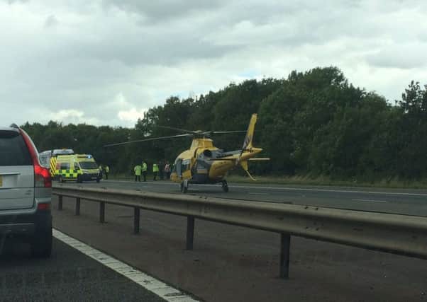 The air ambulance on the M40 after a crash involving a lorry and a pedestrian. Photo by Trevor Tiller NNL-170731-143034001