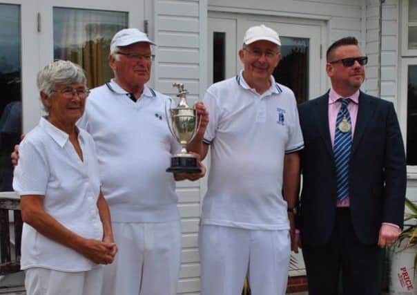 The winning Warwick Mixed Triples teams of June Wright, David Carson and Peter Gawthorpe receive the trophy from Warwick deputy mayor Rich Eddy.