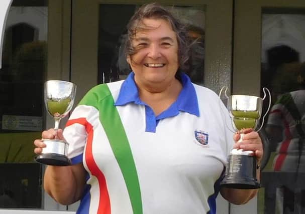 Enid Reece with her two trophies.