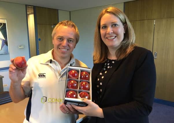 Donna Bothamley presents Ed Smith (holding his match-winning ball) with his prize of six cricket balls.