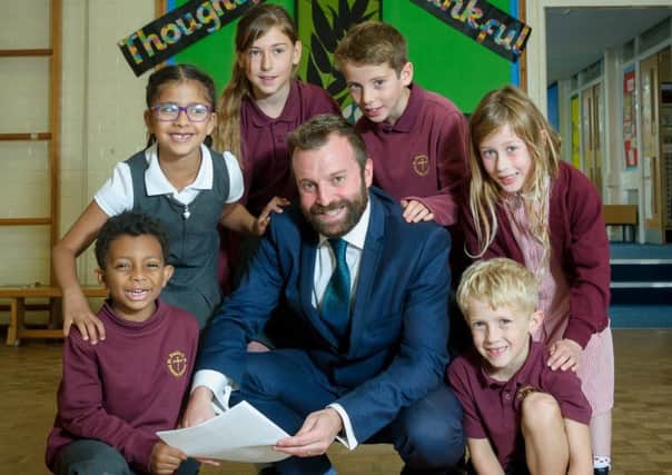 Headteacher, Matthew Brown pictured together with pupils from St. paul's C of E Primary School, are celebrating a recent good Ofsted report. NNL-171209-223807009