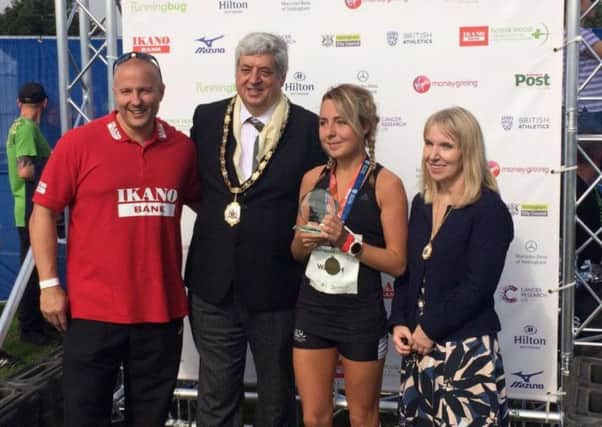 Emily Waugh receiving her trophy after her Robin Hood half marathon victory