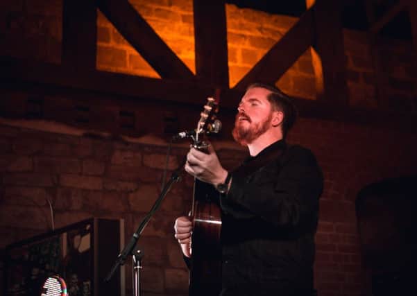 John Smith playing at the Tudor Stables. Photo by Redwood Photography