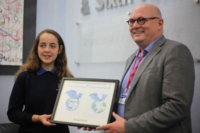 Amy Agoston (left), with Paul Horton showing her logo design