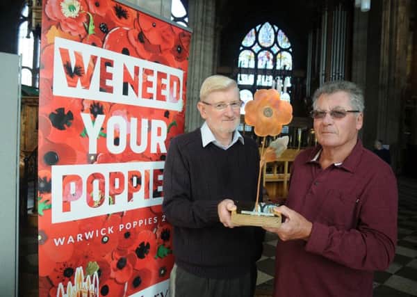 David Benson receives the metal poppy from it's creator Malcolm Knowles.