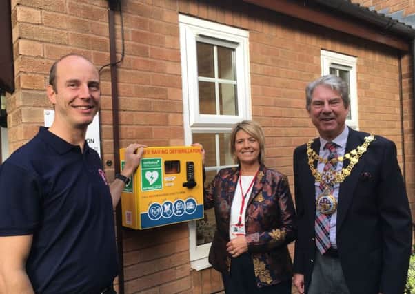 Tim Morris from Warwickshire Hearts, Chief Executive at The Myton Hospices Ruth Freeman and Mayor of Warwick Stephen Cross officially unveil the new defibrillator at Warwick Myton Hospice.