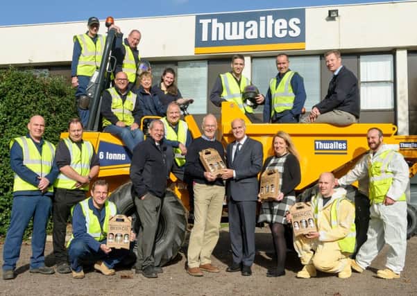 Thwaites have recently celebrated 80 years of manufacturing from the same site in Cubbington. Employees were presented with specially designed pint glasses and two beers in a presentation pack from local brewer The Warwickshire Beer Co. Jerry Lewitt who co-owns the brewery is pictured presenting a gift pack to Thwaites' managing director Ian Brown and employees gathered around one of the company's dumper trucks.