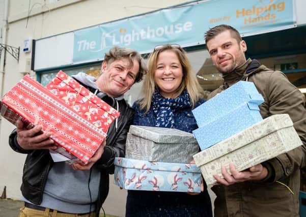 Lianne Kirkham and Staff at the 'Helping Hands' charity shop, held a shoe box appeal for the homeless.  Pictured: Mark Jones, Lianne Kirkham and Arin Hartwell. NNL-171024-235445009