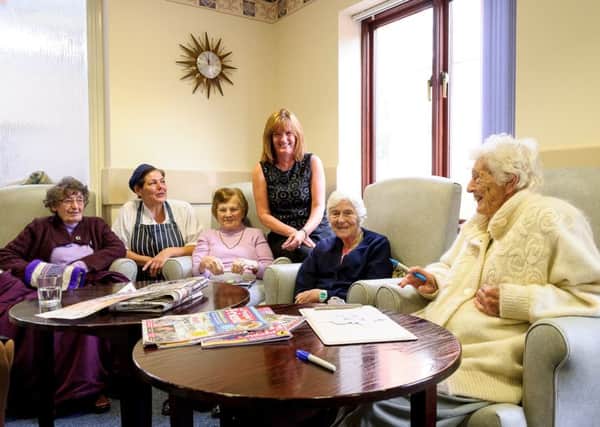 Waverley Day Centre are looking to build attendance numbers, after a drop off in members.  Pictured: Sue Hutchcox (Cook), Ann Vowles together with members, at the centre. NNL-171031-205408009