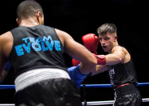 Danny Quartermaine in action against Lewis Frimpony. Pictures: Tim Harris